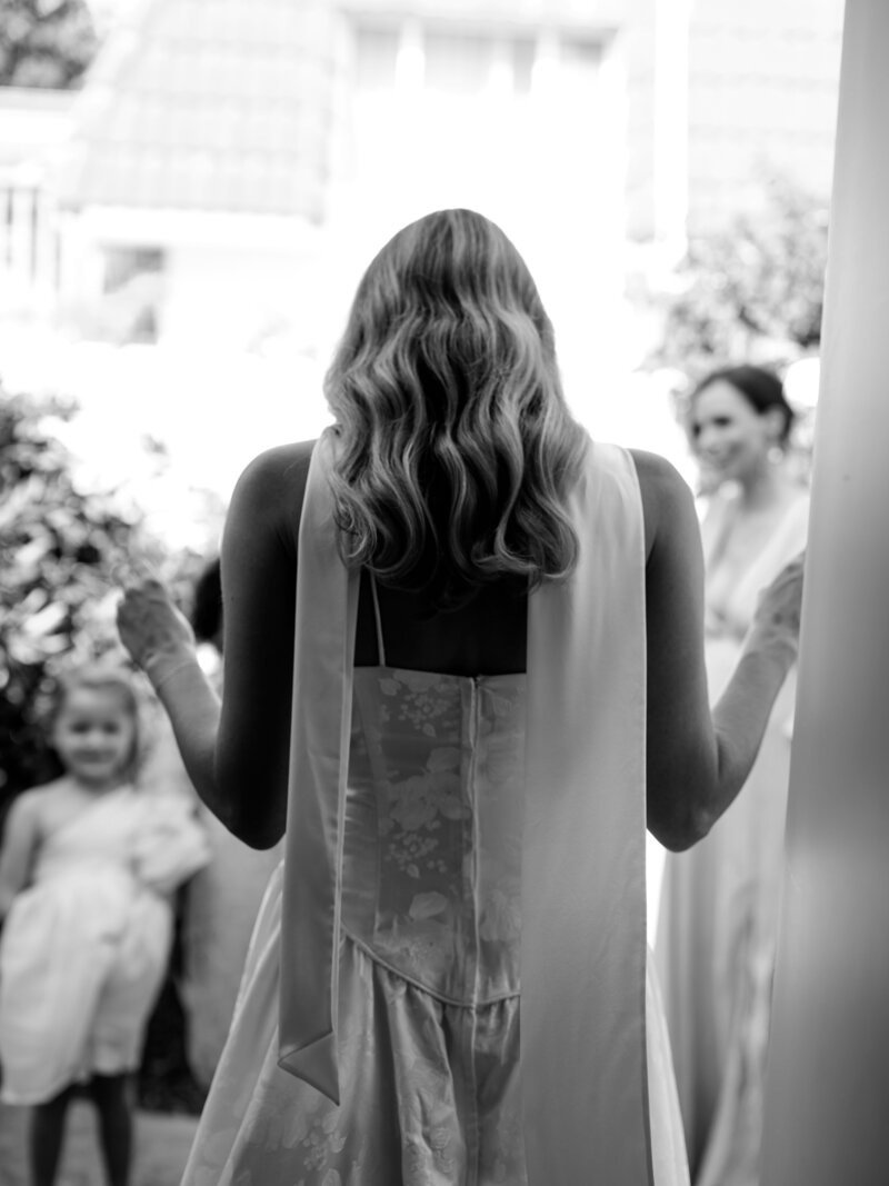 Bride stepping out to family before wedding ceremony in Southern California