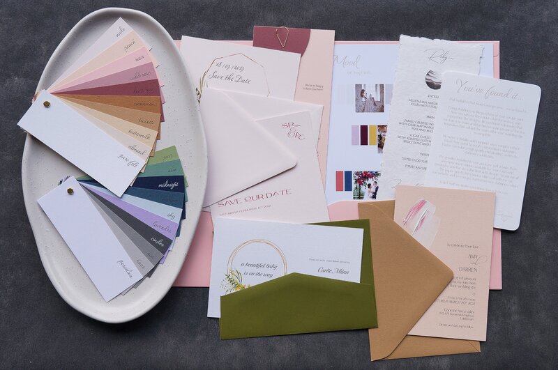 Wedding invitations sample pack with paper swatches, invitations, and a mood board