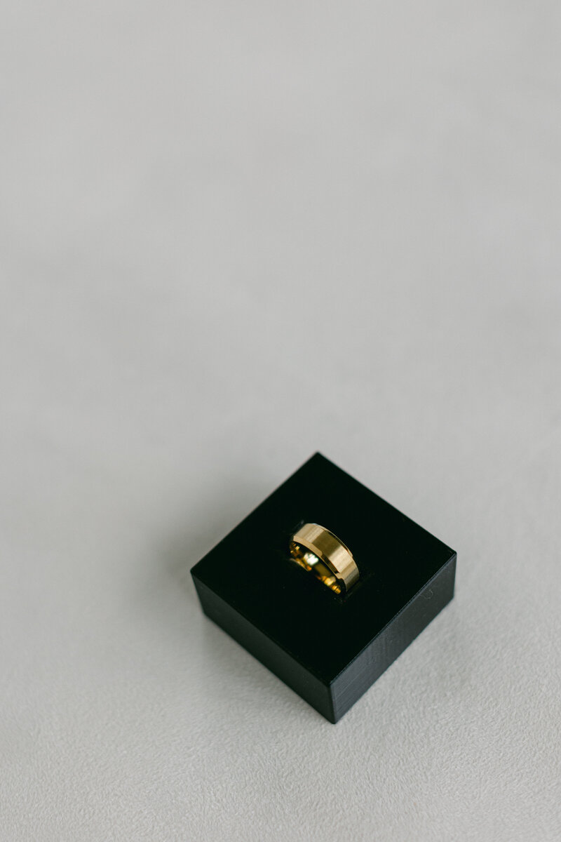 Groom ring insert dish highlighting men's wedding bands in flat lays