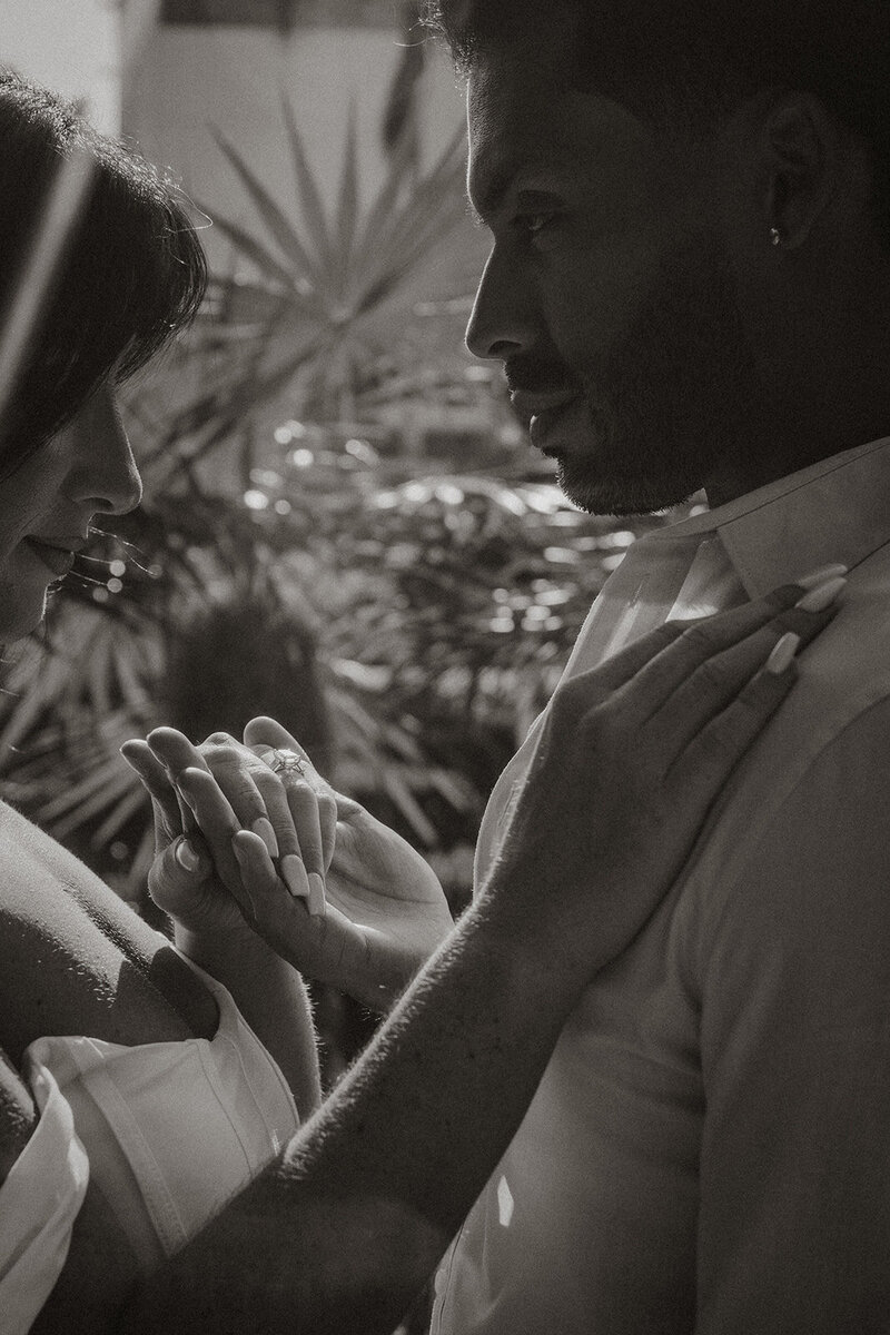 bride and groom hold hands in artistic close up shot