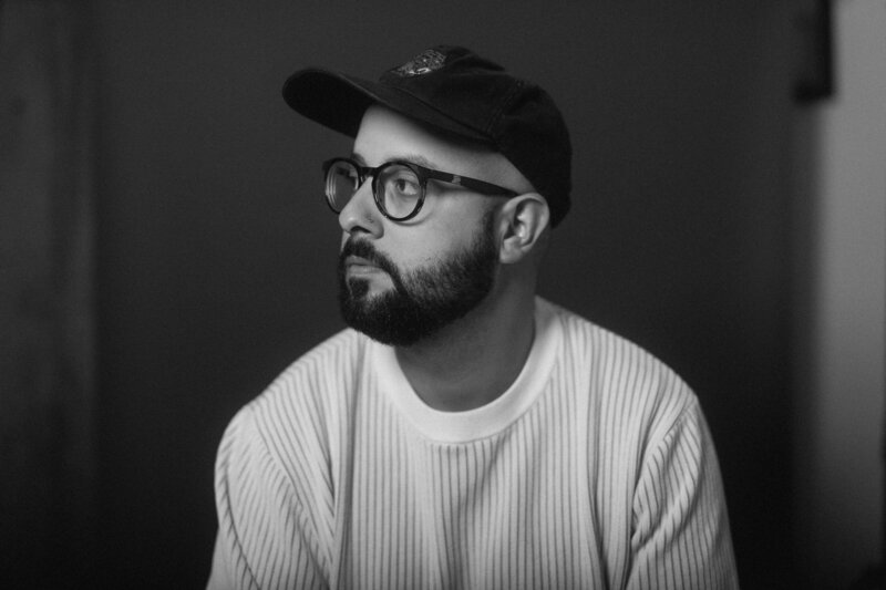 Self-portrait on a blank wall with shadows