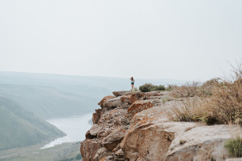 Idaho photographer Lizee Gardner posing on a cliff
