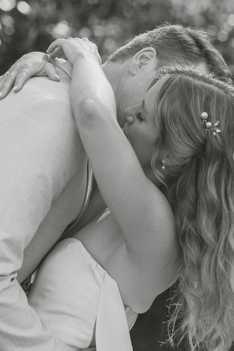 Groom kissing bride during their wedding portraits in Comox by latitude 49 photography