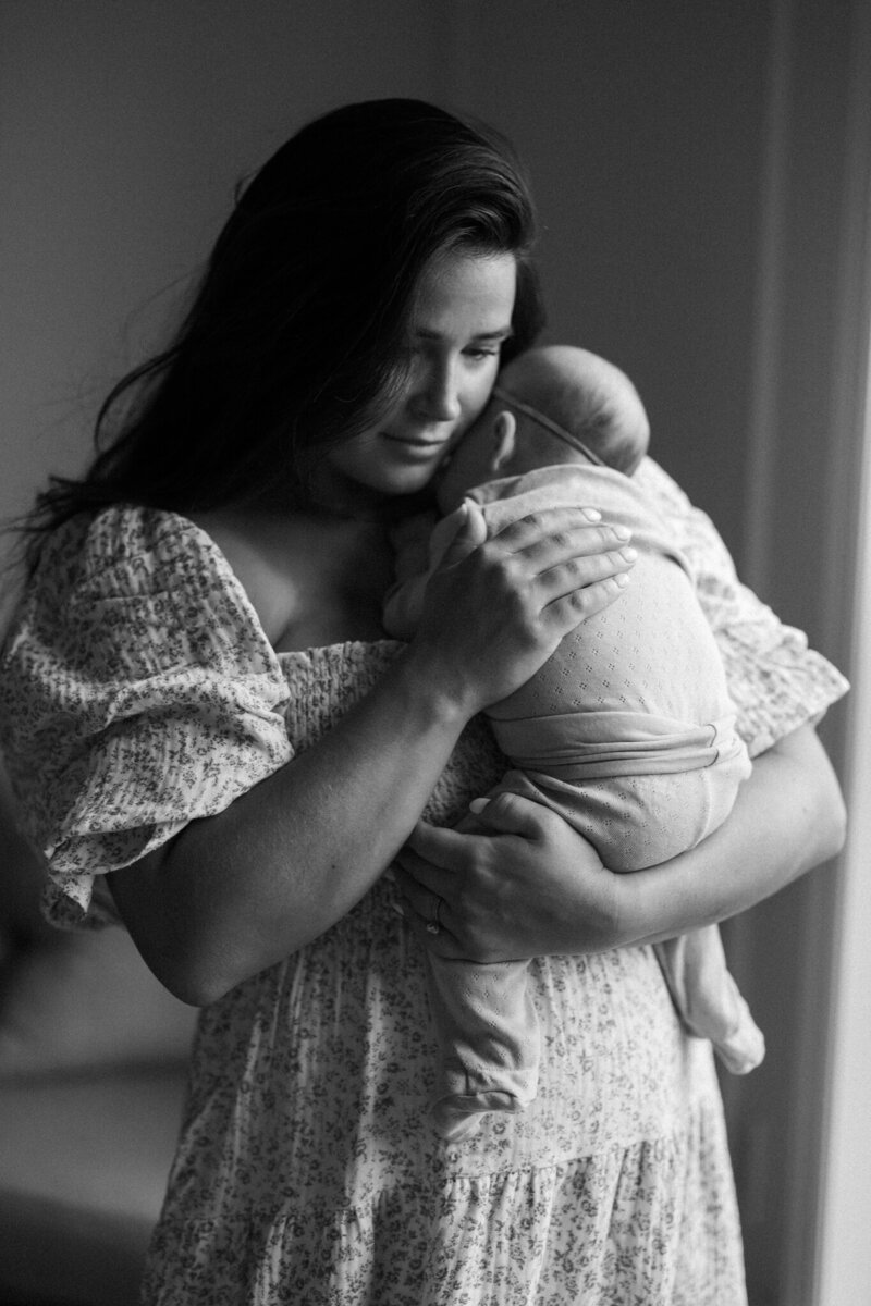 Mom holds baby in black & white photo for family portraits