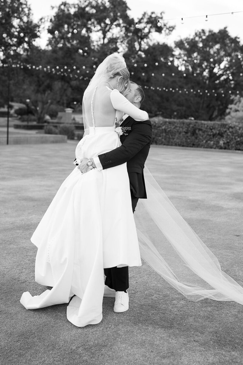 A grayscale photo of a couple while dancing at their Sherwood country Club wedding, in San Luis Obispo California