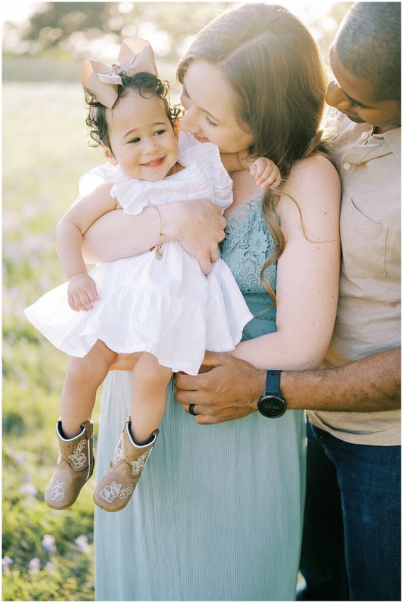 parents holding little girl at sunset Atlanta Family Photographer