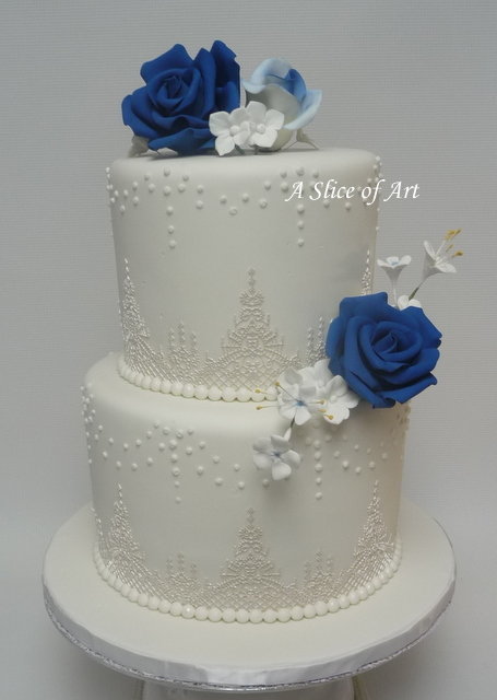 wedding cake with cake lace and royal icing dots sugar roses