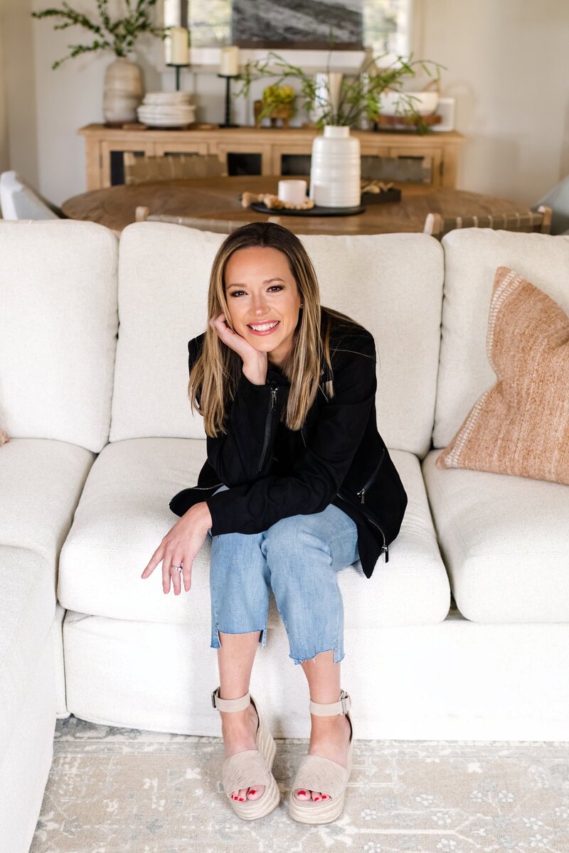 podcaster posing on a couch in north scottsdale home for a branding photo shoot