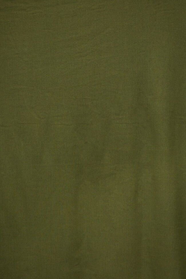 Dark olive green fabric background with subtle grain texture.