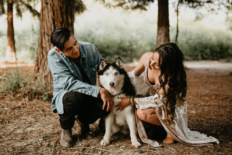 couple posing with dog
