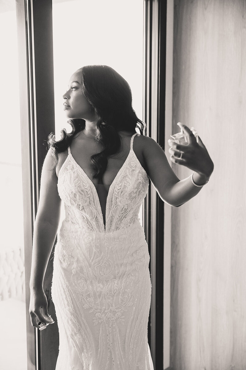 bride sprays perfume before wedding in san diego