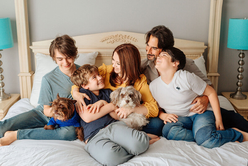 nj newborn and maternity photographer posing with her own family and pets smiling at each other