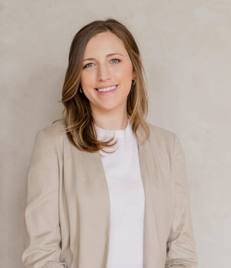 A woman wearing a tan blazer and white shirt, identified as Erin Carpenter, Psy D.