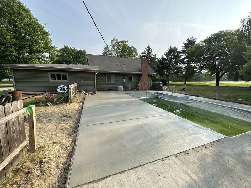 Finished concrete pool deck behind a ranch home in Goshen, IN