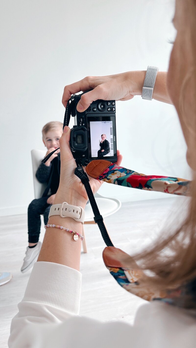 female photographer photographing a family at home