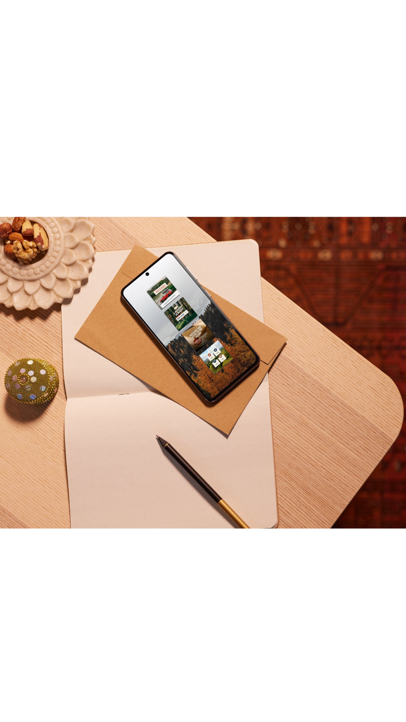 black podcast mic sitting on desk with women working