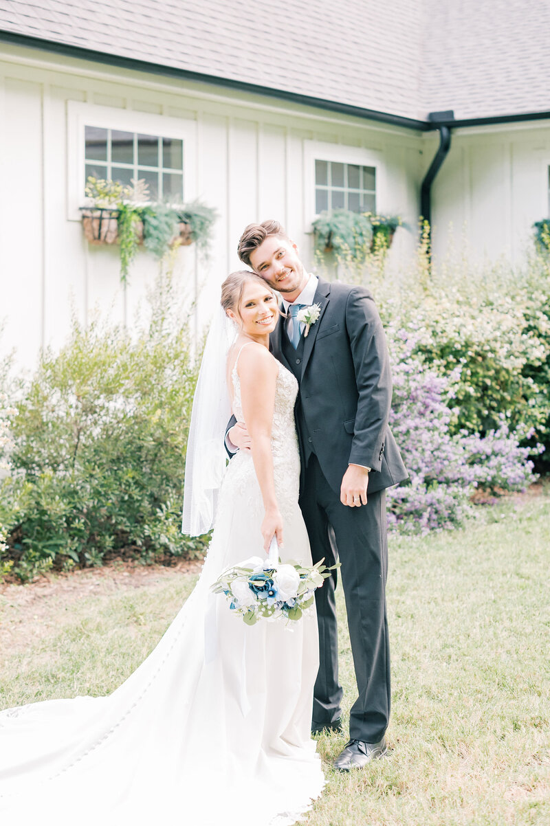 The RoseMary Wedding Venue | DFW Wedding Photographer Rae De Lain Light and Airy | Bride and groom standing next to each other smiling