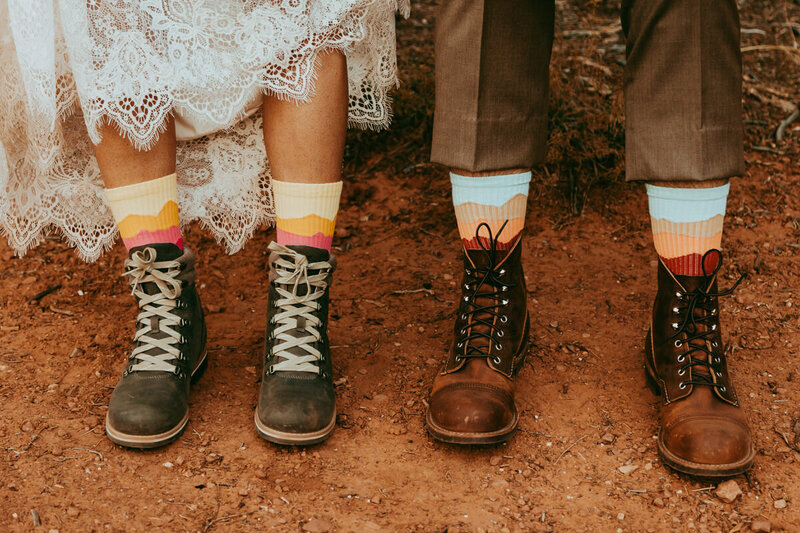 mana nd woman wearing hiking boots and wedding attire