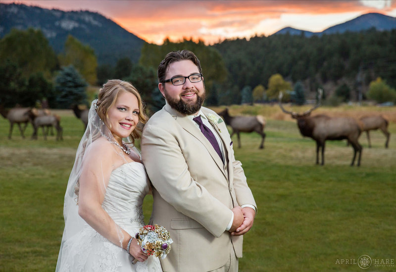 Incredible photo of couple at sunset with bugling elk in the backdrop at Evergreen Lake House in Colorado