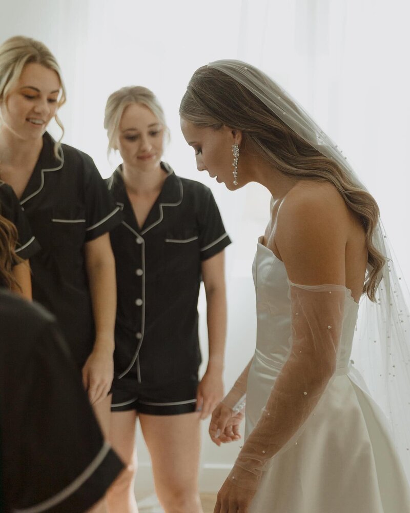 The bride and a bridesmaid sharing a moment while getting ready in the August House Venue's bridal suite.