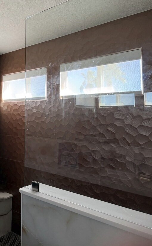 Cordless solar roller shades on clerestory windows inside a walk-in shower in Las Vegas