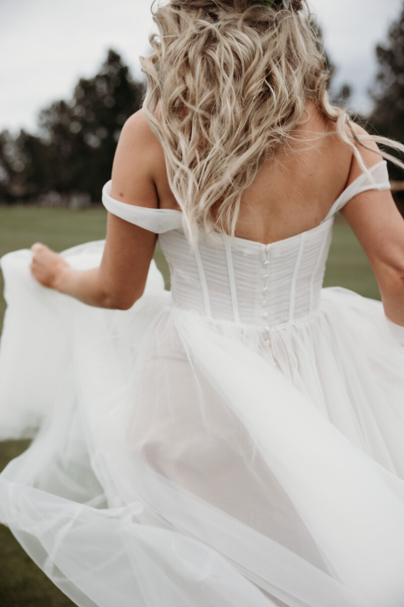 bride running through field