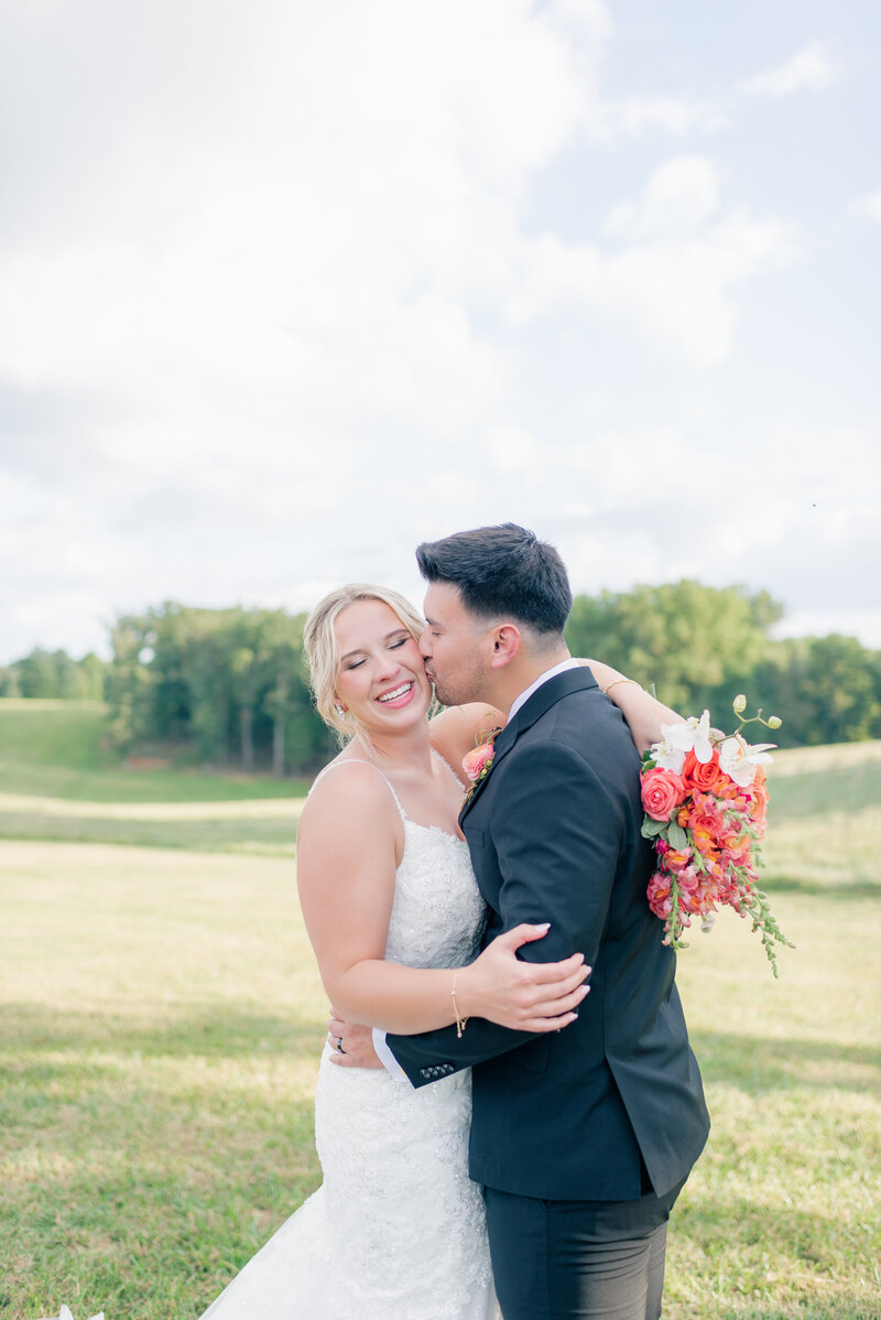 Newlyweds share a kiss during newly wed portraits