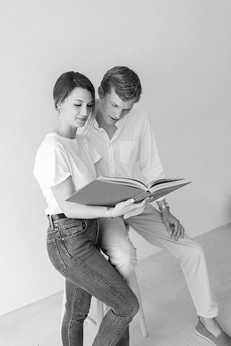man and woman looking at a design book together