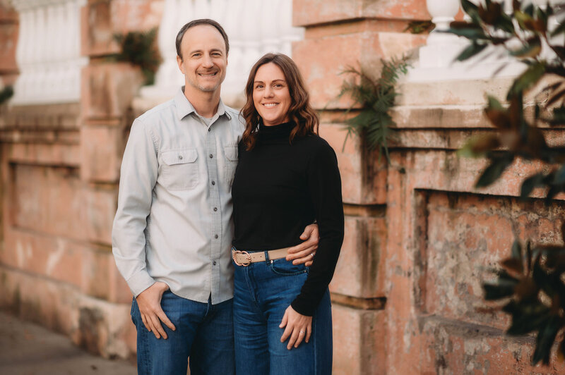Husband and wife embrace during Family Photos in Charleston.