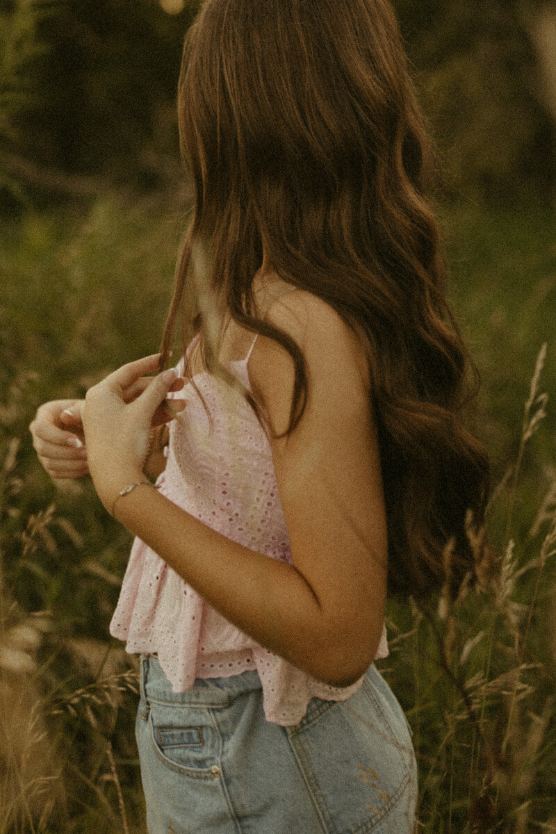 senior photos in a white dress and cowboy boots
