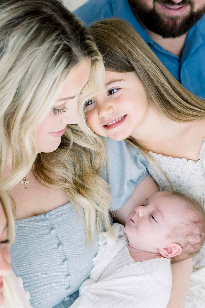 Parents with their toddler and newborn