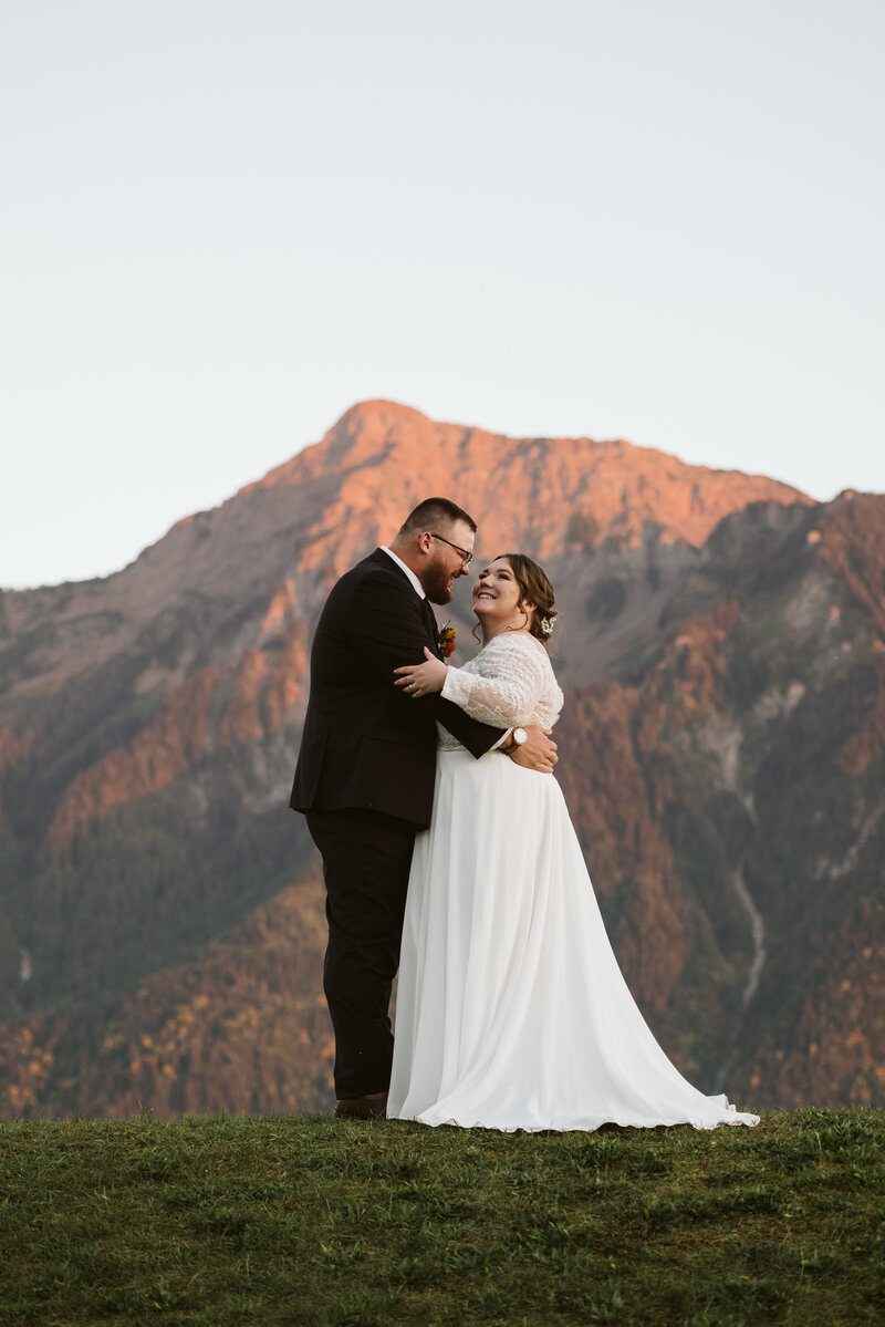 A couple embracing in front of Mt. Cheam at the Fraser River Lodge in Chilliwack