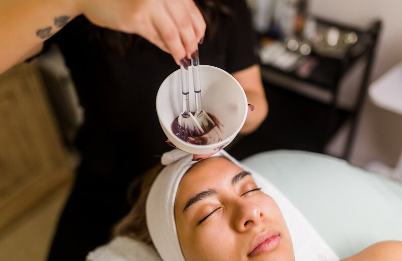 esthetician applying face mask