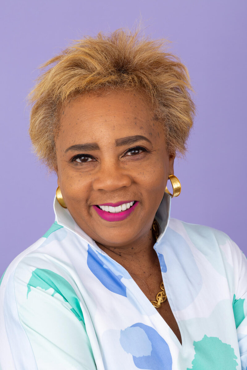 Woman in pink lipstick on lavender backdrop