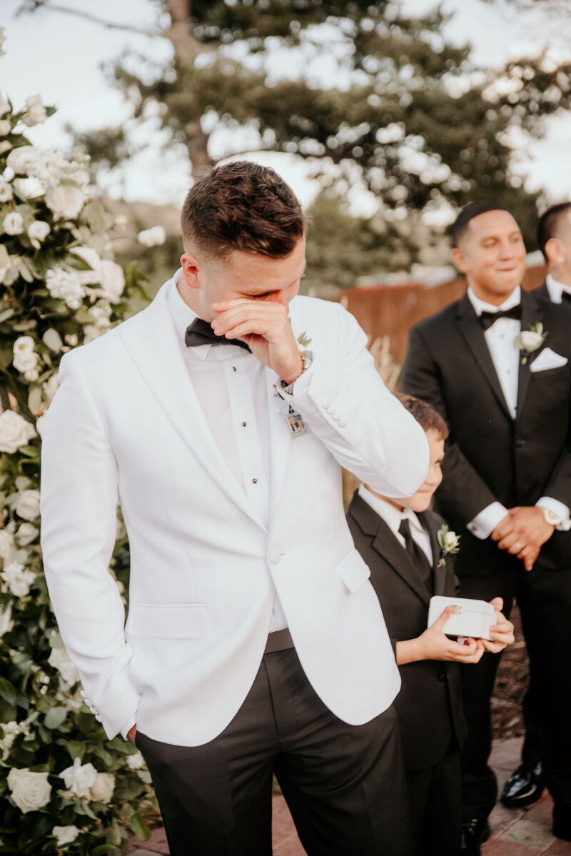 Bride cries during group prayer before wedding