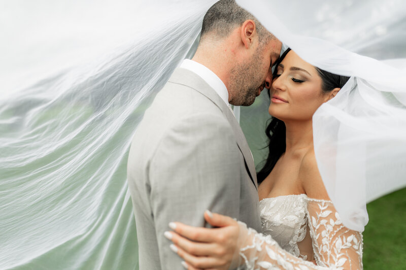 groom embraces bride at Adamo Estate Winery