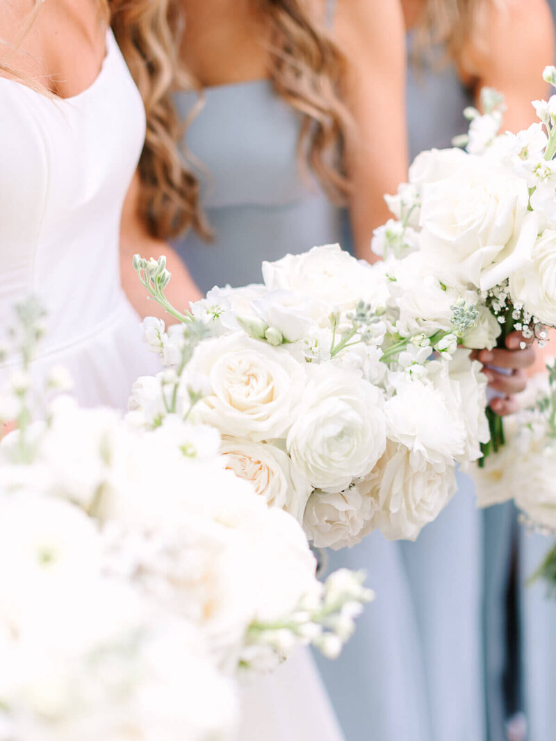 bride and bridesmaids holding bouquets at wedding planned by wedding planner mn