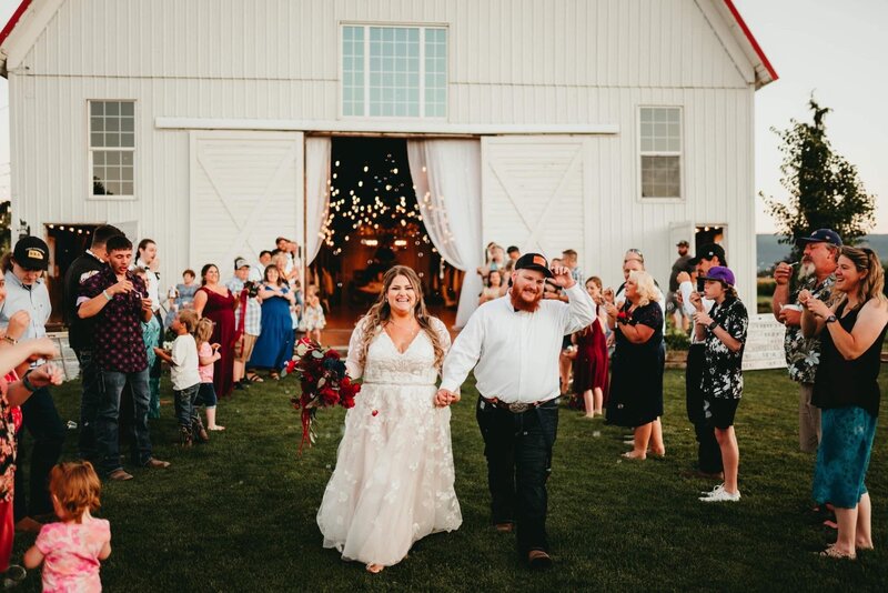Bride and groom fist dance in barn venue