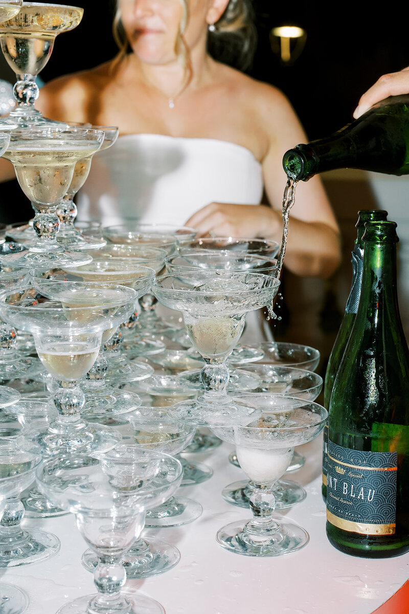 Bride and groom pouring champagne tower