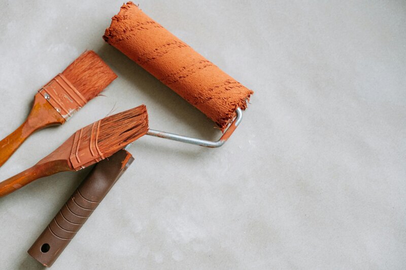 Paint roller and paint brushes with orange paint