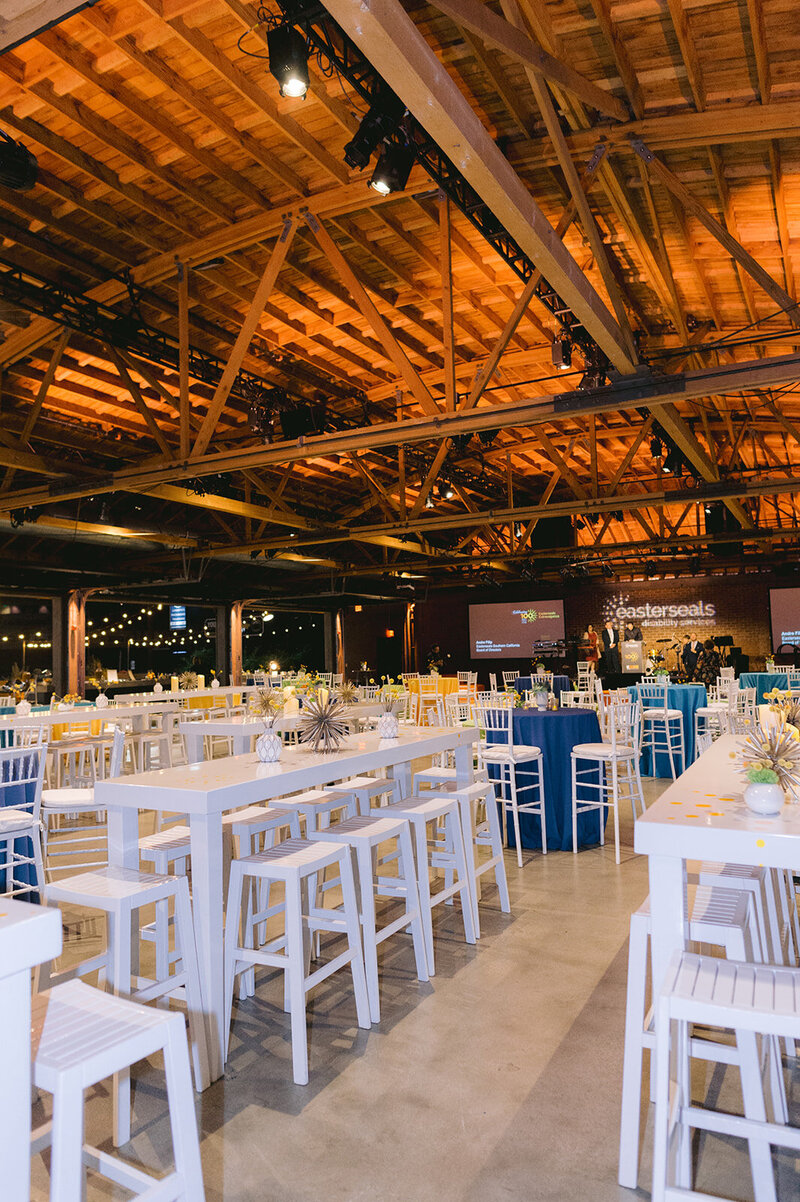 outdoor tended wedding reception with large bouquets and trailing ivy