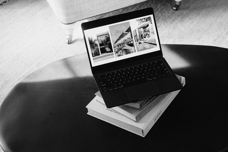 Black and white image of a laptop showcasing a website