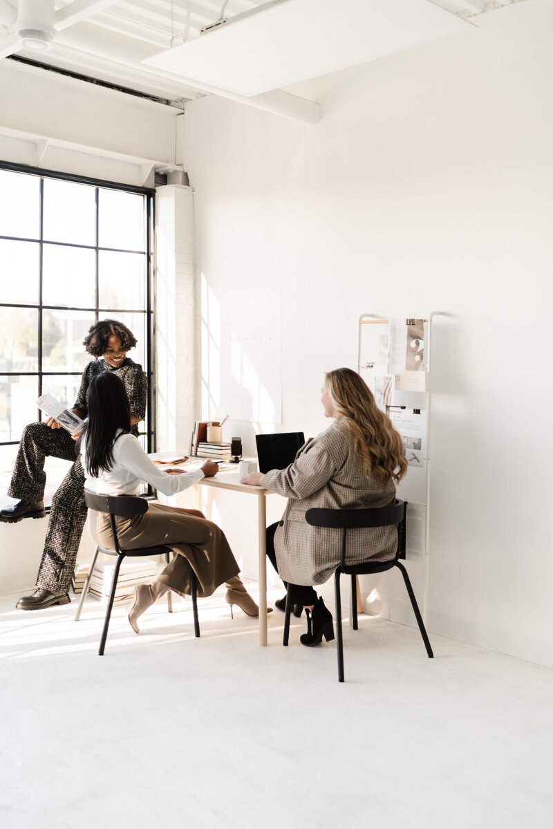 Studio with 3 entrepreneurs working at a desk