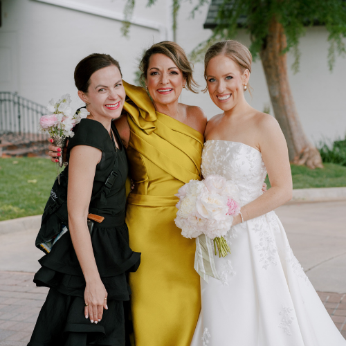 Meg Owen standing with a bride and groom on their wedding day