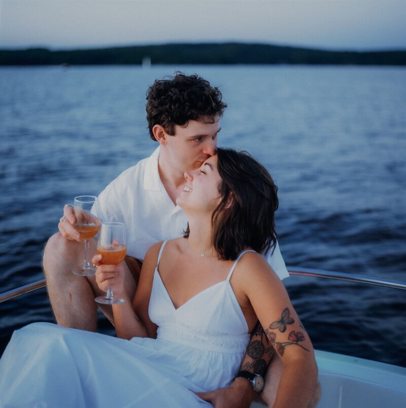 An engaged couple on their boat on Lake Champlain in Burlington Vermont