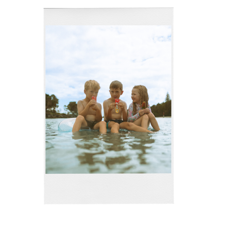 Three kids sitting on a pool float in Evans Head river