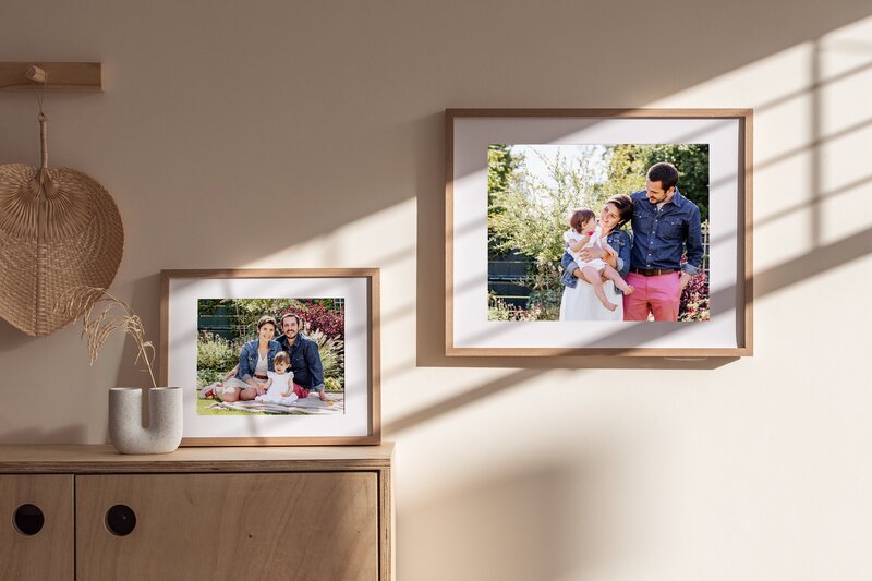 a wall with two framed family pictures