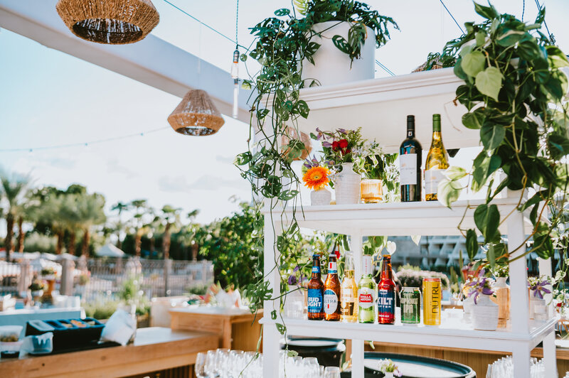 Stylish outdoor bar setup with greenery, florals, and premium beverage branding—photographed at a corporate event by MISGIF in Phoenix, Arizona.