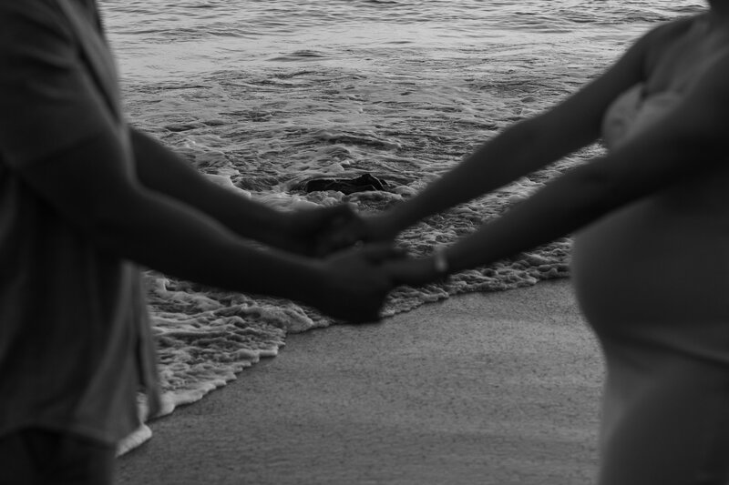 black and white moody maternity photo at the beach in california