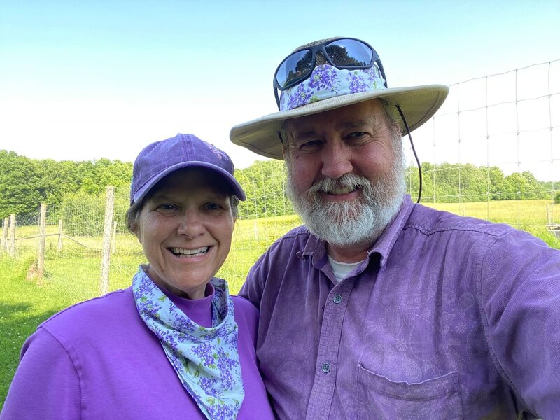 Wil and Rebecca Rivers owners of North Country Lilacs smiling on their lilac farm in Canton, New York